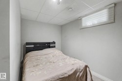 Wall-to-wall carpeting and a drop ceiling with recessed lighting - 
