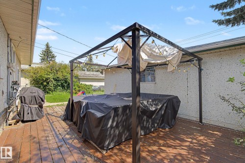 Wood-finish deck with a metal frame gazebo and string lighting - 4323 114B Street Nw, Edmonton, AB - Outdoor With Deck Patio Veranda With Exterior