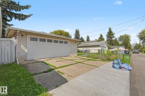 Detached garage with a paneled door, offering convenient access to the rear alley - 4323 114B Street Nw, Edmonton, AB - Outdoor