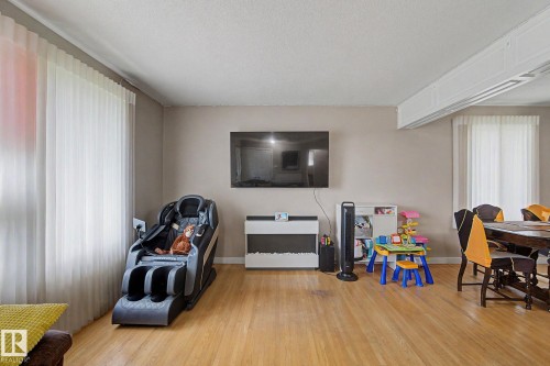 Hardwood flooring, neutral painted walls, and white window treatments - 4323 114B Street Nw, Edmonton, AB - Indoor