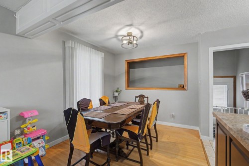 Wood-finish flooring, white window treatments, and an overhead light fixture - 4323 114B Street Nw, Edmonton, AB - Indoor Photo Showing Other Room