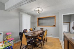 Wood-finish flooring, white window treatments, and an overhead light fixture - 