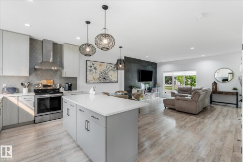 Open-concept living space featuring wood-finish flooring and recessed lighting - 9 Dillingham Avenue, Fort Saskatchewan, AB - Indoor Photo Showing Kitchen With Upgraded Kitchen