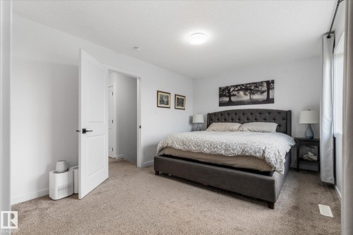 Spacious bedroom featuring neutral carpeting, white walls, and a recessed ceiling light fixture - 9 Dillingham Avenue, Fort Saskatchewan, AB - Indoor Photo Showing Bedroom