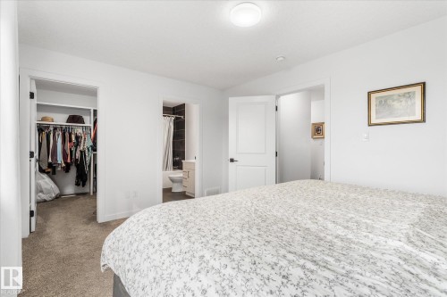 Carpeted bedroom with a built-in closet, flush mount ceiling light, and white walls - 9 Dillingham Avenue, Fort Saskatchewan, AB - Indoor Photo Showing Bedroom