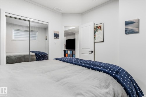 Mirrored closet doors, crisp white walls, and a white interior door with matte black hardware - 9 Dillingham Avenue, Fort Saskatchewan, AB - Indoor Photo Showing Bedroom