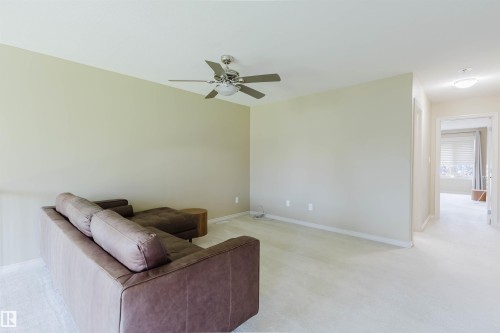 Neutral wall paint, ceiling fan with integrated lighting, recessed lighting, and carpeted flooring - 864 Armitage Wynd Sw, Edmonton, AB - Indoor Photo Showing Other Room