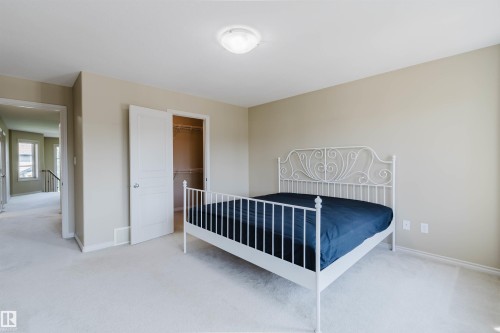 Neutral wall color, wall-to-wall carpeting, overhead lighting, single window, and a built-in closet - 864 Armitage Wynd Sw, Edmonton, AB - Indoor Photo Showing Bedroom