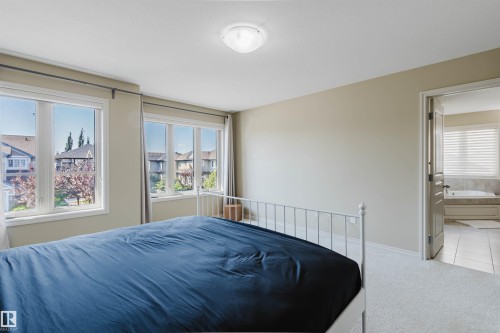 Carpeted bedroom with neutral wall tones and a flush-mount ceiling light - 864 Armitage Wynd Sw, Edmonton, AB - Indoor Photo Showing Bedroom