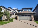 Contemporary exterior with mixed siding and stone accents, a multi-pane garage door, and a gravel driveway - 864 Armitage Wynd Sw, Edmonton, AB  - Outdoor 