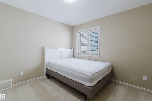 Neutral paint palette, carpeted flooring, window with blinds, and white trim - 864 Armitage Wynd Sw, Edmonton, AB - Indoor Photo Showing Bedroom