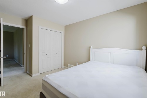 Neutral-toned walls complement the light-colored carpeting - 864 Armitage Wynd Sw, Edmonton, AB - Indoor Photo Showing Bedroom
