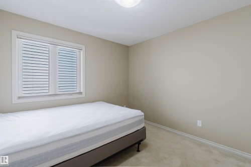 Neutral wall color with white trim, window with blinds, and light-colored carpet - 864 Armitage Wynd Sw, Edmonton, AB - Indoor Photo Showing Bedroom