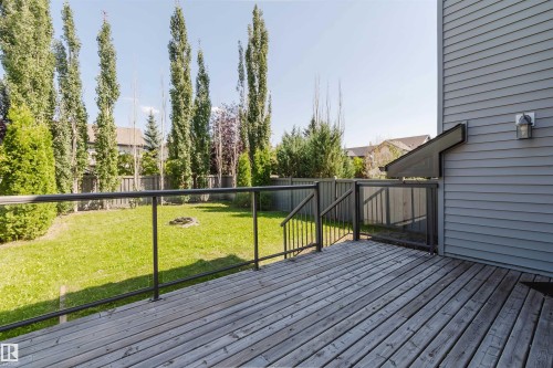 Wood-finish deck with glass panel railings - 864 Armitage Wynd Sw, Edmonton, AB - Outdoor With Deck Patio Veranda