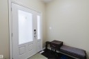 Entry door with frosted glass paneling and a coordinating sidelite - 864 Armitage Wynd Sw, Edmonton, AB  - Indoor Photo Showing Other Room 