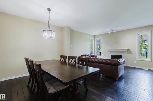 Dark wood-finish flooring throughout - 864 Armitage Wynd Sw, Edmonton, AB - Indoor With Fireplace