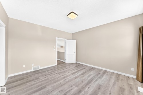 Wood-finish flooring, neutral wall tones, and overhead lighting - 16227 64 Street Nw, Edmonton, AB - Indoor Photo Showing Other Room