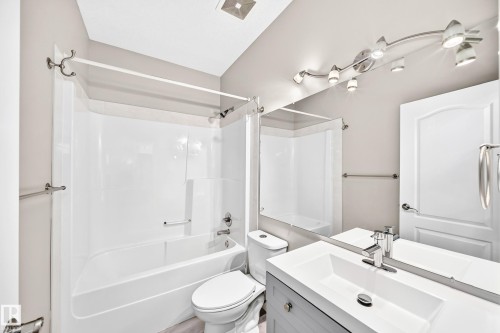 Integrated tub and shower combination with chrome fixtures - 16227 64 Street Nw, Edmonton, AB - Indoor Photo Showing Bathroom