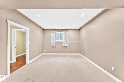 Recessed ceiling lighting, neutral carpet flooring, and a window with white trim - 16227 64 Street Nw, Edmonton, AB - Indoor Photo Showing Other Room