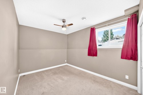 Carpeted room with a ceiling fan, recessed lighting, and a white-framed window - 16227 64 Street Nw, Edmonton, AB - Indoor
