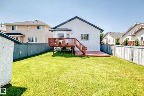 Expansive lawn with a wood fence perimeter - 16227 64 Street Nw, Edmonton, AB - Outdoor With Deck Patio Veranda With Exterior