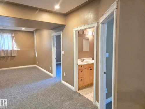 Recessed ceiling lighting, light gray carpeting, white trim, wood-finish vanity, and tiled flooring - 16227 64 Street Nw, Edmonton, AB - Indoor Photo Showing Other Room