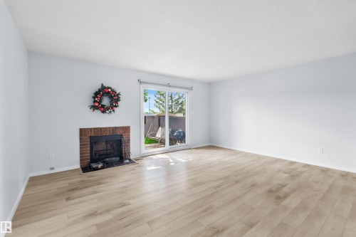 117 Tudor Lane Nw, Edmonton, AB - Indoor Photo Showing Living Room With Fireplace