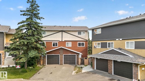 Multi-level townhome featuring a double garage, brown brick facade, and brown siding - 10644 158 Avenue Nw, Edmonton, AB - Outdoor