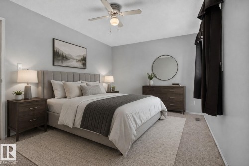 Spacious room featuring light gray walls, textured carpeting, and a ceiling fan with integrated lighting - 10644 158 Avenue Nw, Edmonton, AB - Indoor Photo Showing Bedroom