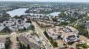 Aerial perspective featuring a residential area with a prominent body of water, extensive green spaces, and dense tree coverage - 10644 158 Avenue Nw, Edmonton, AB  - Outdoor With Body Of Water With View 