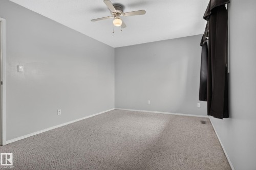 Carpeted interior space with light grey walls and white baseboards - 10644 158 Avenue Nw, Edmonton, AB - Indoor Photo Showing Other Room