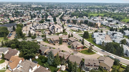 Aerial perspective showcasing a residential area with varied housing types, established tree cover, and a network of roadways - 10644 158 Avenue Nw, Edmonton, AB - Outdoor With View