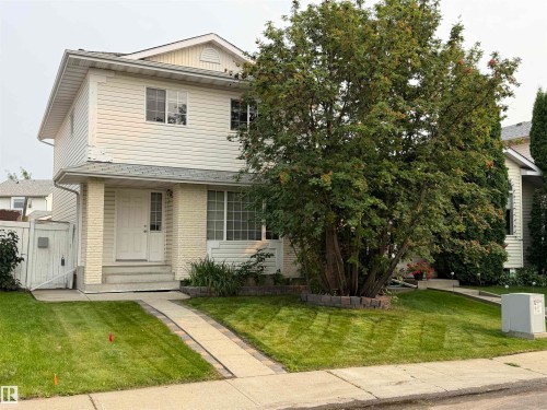 Two-story exterior with light-colored siding and brick accents - 1535 80A Street Nw, Edmonton, AB - Outdoor