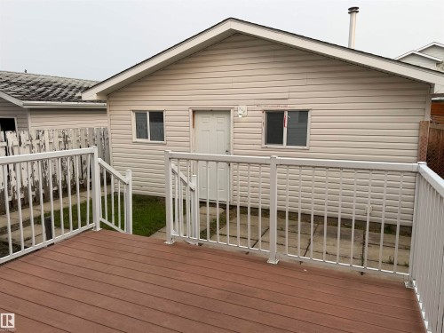 Deck with composite decking, white aluminum railing, and access to a detached structure with siding - 1535 80A Street Nw, Edmonton, AB - Outdoor With Deck Patio Veranda With Exterior
