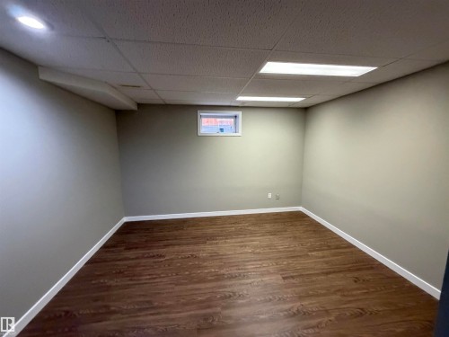 Recessed lighting, wood-finish flooring, drop ceiling, and a single window - 1535 80A Street Nw, Edmonton, AB - Indoor Photo Showing Basement