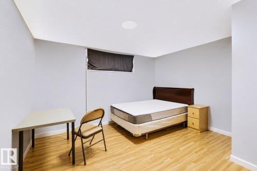Recessed ceiling lighting, wood-finish flooring, and a window with a privacy blind - 8723 81 Avenue Nw, Edmonton, AB - Indoor Photo Showing Bedroom
