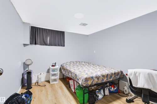 Recessed ceiling lighting, light wood-finish flooring, and a window with blinds - 8723 81 Avenue Nw, Edmonton, AB - Indoor Photo Showing Bedroom