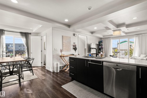 Kitchen featuring dark wood-finish flooring, recessed lighting, and a tray ceiling - 15713 102 Avenue Nw, Edmonton, AB - Indoor