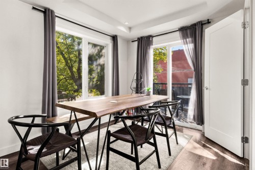 Hardwood-finish flooring, recessed ceiling lighting, a white door, and a built-in balcony - 15713 102 Avenue Nw, Edmonton, AB - Indoor Photo Showing Dining Room