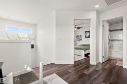 Wood-finish flooring, recessed lighting, and white interior doors - 