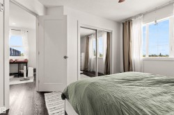 Wood-finish flooring throughout, white interior doors, and sliding mirrored closet doors - 