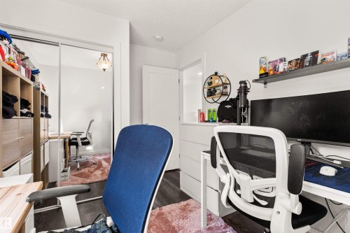 Mirrored closet doors, dark wood-finish flooring, and white walls - 15713 102 Avenue Nw, Edmonton, AB - Indoor Photo Showing Office