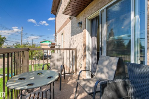 Private balcony with stucco exterior, metal railing, and glass sliding door - 15713 102 Avenue Nw, Edmonton, AB - Outdoor With Balcony With Exterior