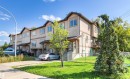 Multi-level townhome exterior featuring stucco siding, gabled rooflines, multiple windows, and a private balcony - 15713 102 Avenue Nw, Edmonton, AB  - Outdoor 