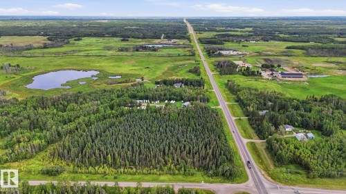 Expansive land featuring mature trees, open fields, and a natural pond - 52012 Hwy 21, Rural Strathcona County, AB - Outdoor With View