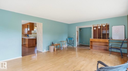 Hardwood flooring throughout, with a built-in wood-finish shelving unit - 52012 Hwy 21, Rural Strathcona County, AB - Indoor