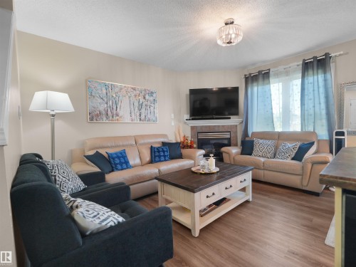 #90 5001 62 St, Beaumont, AB - Indoor Photo Showing Living Room With Fireplace