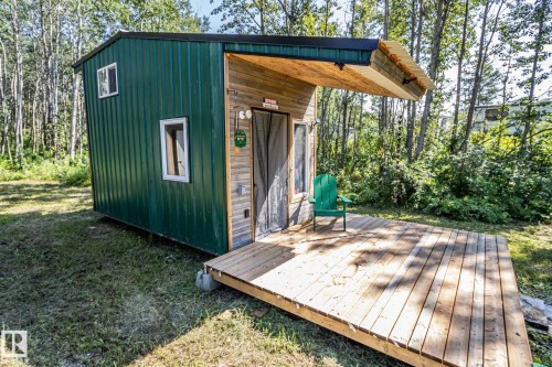 Green corrugated metal siding with wood-finish accent wall - 347, 58532 Range Rd 113, Rural St. Paul County, AB 