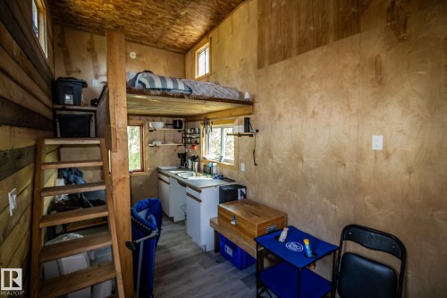 Wood-paneled interior with a lofted sleeping area - 347, 58532 Range Rd 113, Rural St. Paul County, AB 