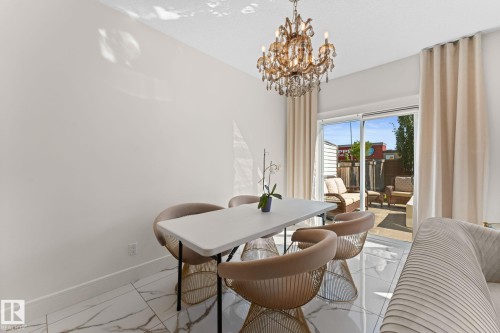 White tile flooring with dark veining - 5415 167A Avenue Nw, Edmonton, AB - Indoor Photo Showing Dining Room